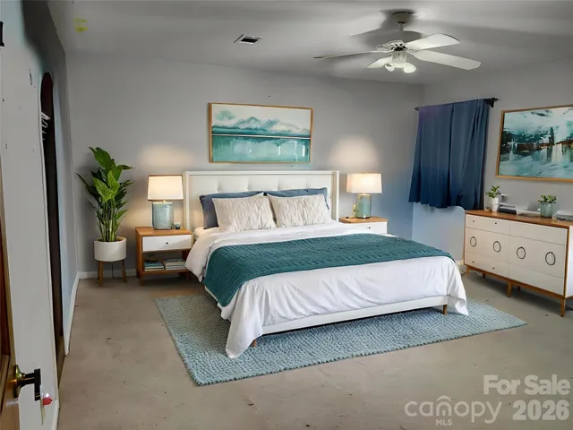 a bedroom with a bed and a window