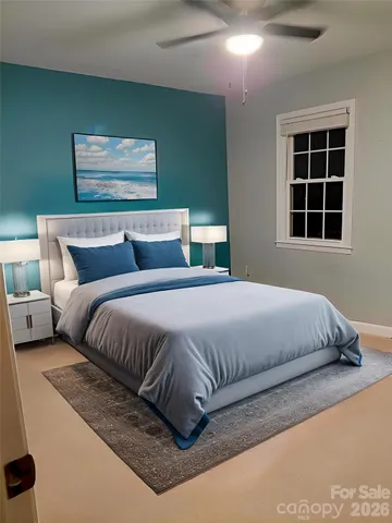 a bedroom with a large bed and a window