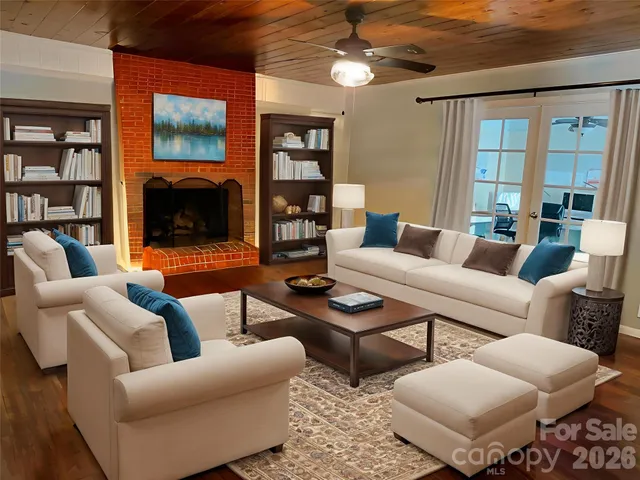 a living room with furniture a flat screen tv and a fireplace