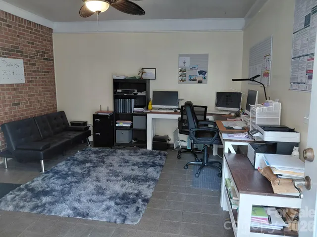 a living room with furniture a rug and a fireplace