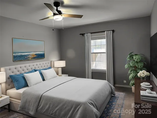 a bedroom with a bed and a potted plant