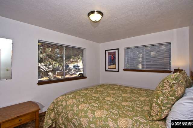 158 A Tramway Drive Stateline, NV 89449 - Photo 8 of 9 a bedroom with a bed and painting on the wall
