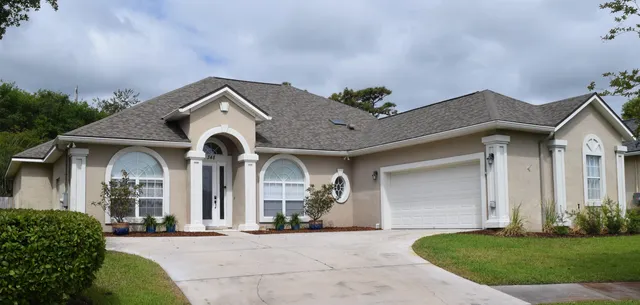 a front view of a house with a yard and garage