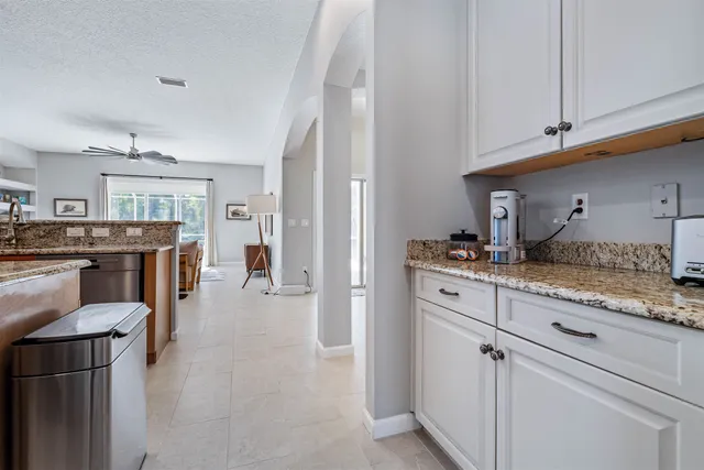 a kitchen with stainless steel appliances granite countertop a refrigerator and stove