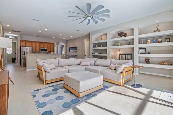 a living room with furniture and a book shelf