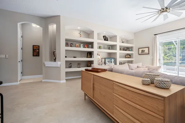 a living room with stainless steel appliances furniture and decor