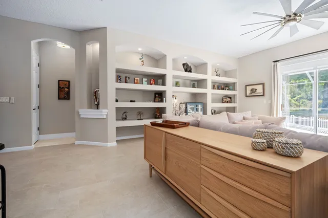 a living room with stainless steel appliances furniture and decor