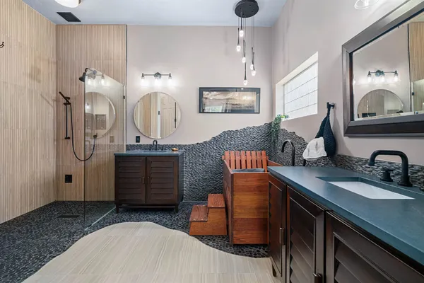 a bathroom with double vanity sink and a mirror