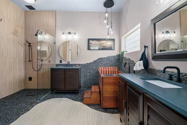 a bathroom with double vanity sink and a mirror