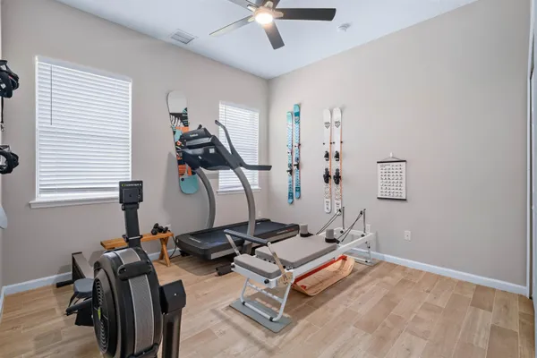a room with gym equipment and windows