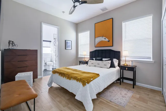 a bed sitting in a bedroom next to a window