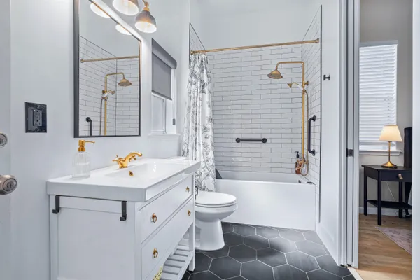 a bathroom with a sink toilet and shower