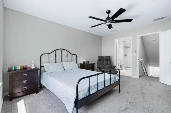 a bedroom with a bed and a ceiling fan