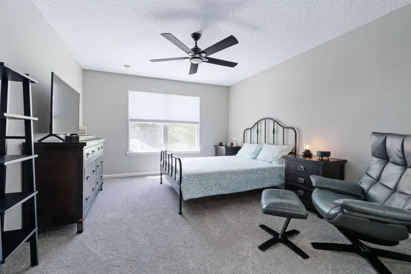 a bedroom with furniture and a window