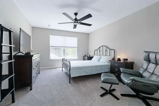 a bedroom with furniture and a window