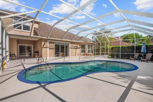 a view of a house with a swimming pool and sitting area