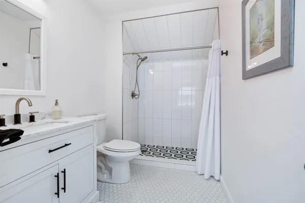 a bathroom with a sink toilet and shower