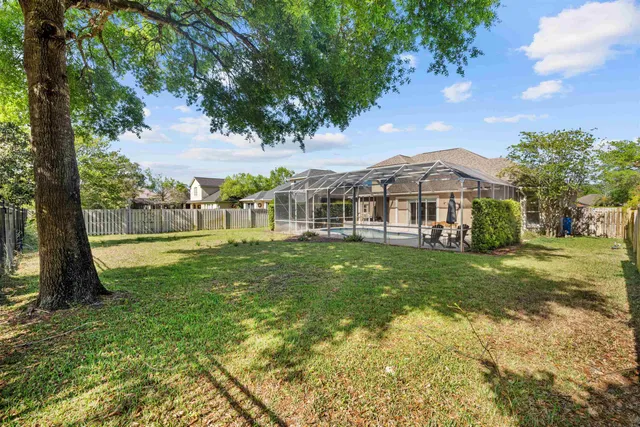 a view of a yard with a house in the background