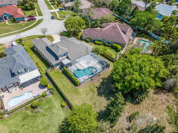 an aerial view of house with yard swimming pool and outdoor seating