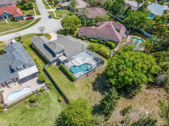an aerial view of house with yard swimming pool and outdoor seating
