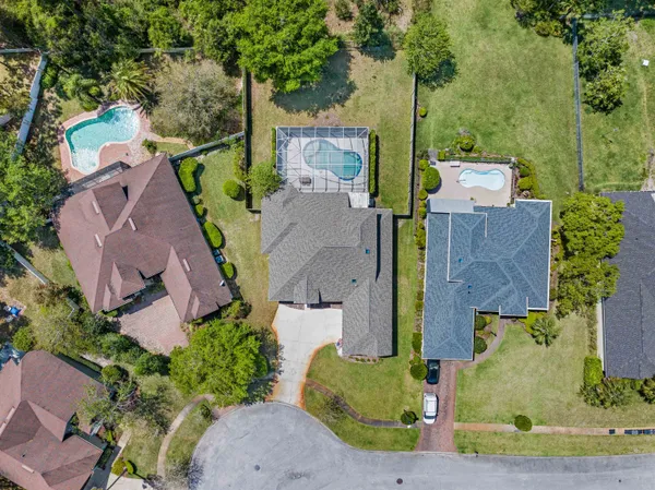 an aerial view of a house with yard swimming pool and outdoor seating