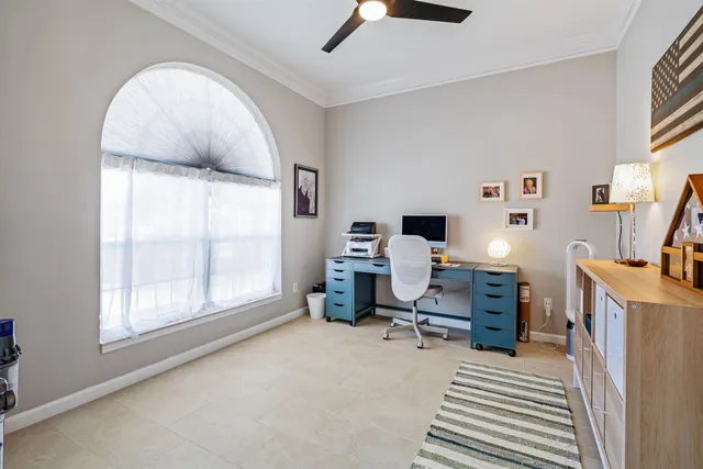 a view of a workspace with furniture and a window