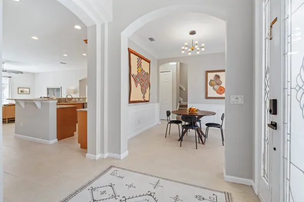 a view of a dining room with furniture and a chandelier