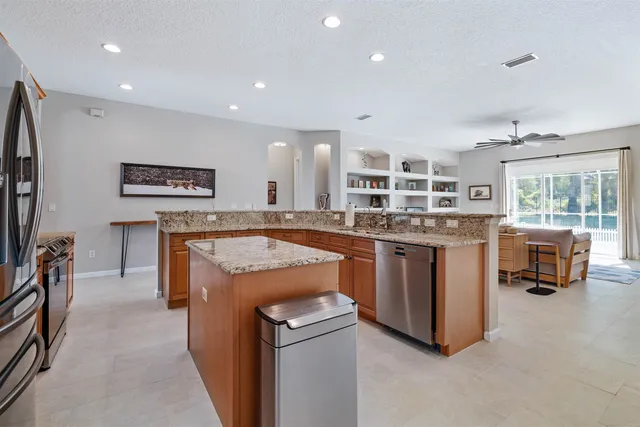 a kitchen with a stove a refrigerator and a sink