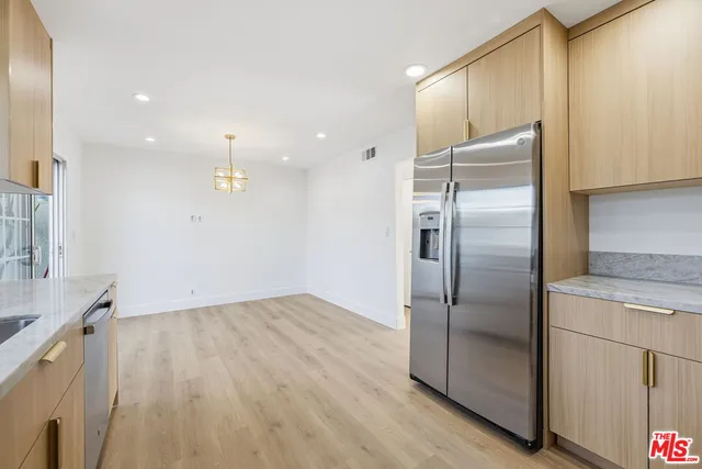 a view of a room with wooden floor and fan