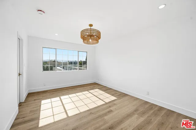 a view of a room with wooden floor and windows