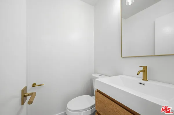 a kitchen with a refrigerator a stove top oven a sink and dishwasher