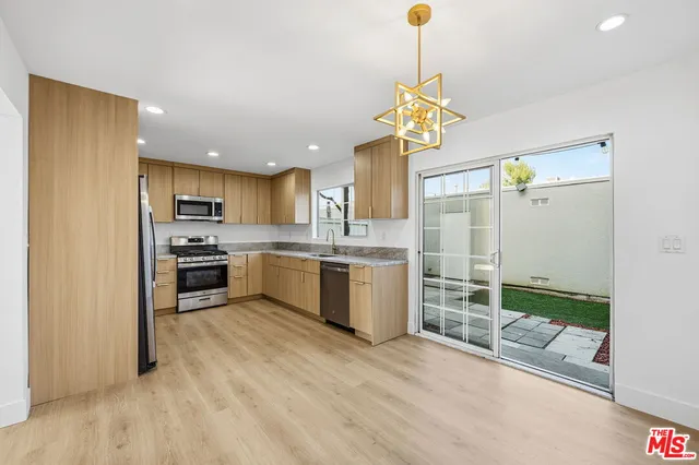a kitchen with a refrigerator a stove top oven a sink and dishwasher
