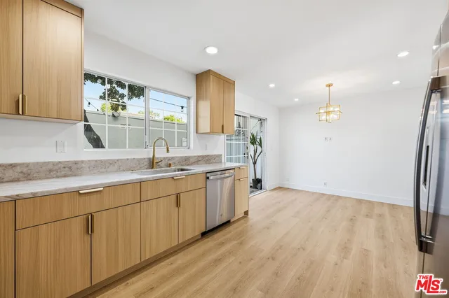 a view of a kitchen with a sink and refrigerator