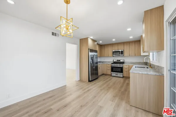 a view of a room with wooden floor and window