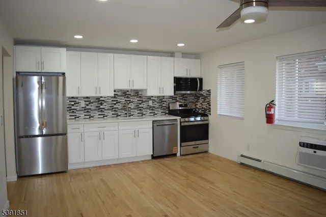 a kitchen with stainless steel appliances granite countertop a refrigerator sink and stove