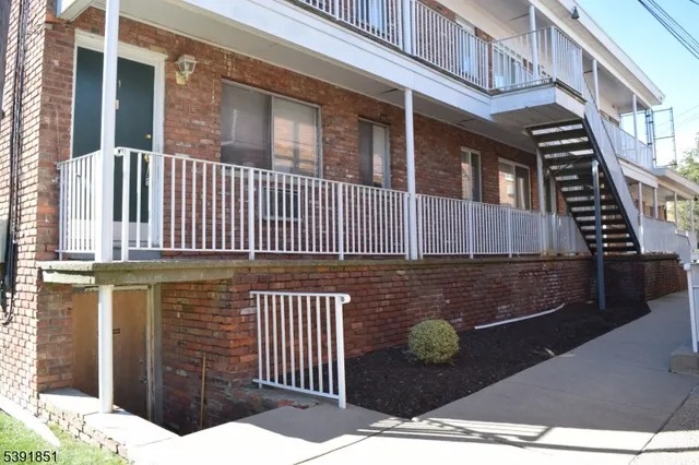 a view of a brick house with many windows