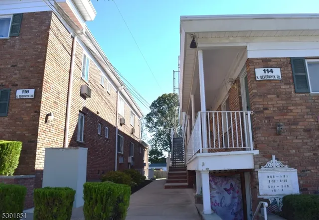 a front view of a house with plants
