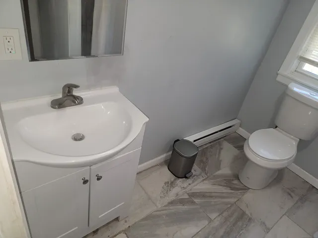 a white toilet sitting next to a bathroom sink