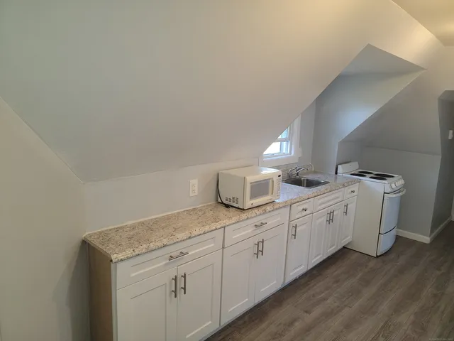 a kitchen with appliances a sink and cabinets