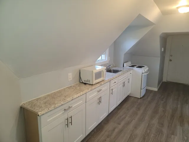 a utility room with cabinets washer and dryer