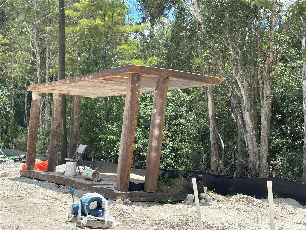 12880 Tower Road Bonita Springs, FL 34135 - Photo 20 of 25 a view of a patio with a table chairs and a floor to ceiling window