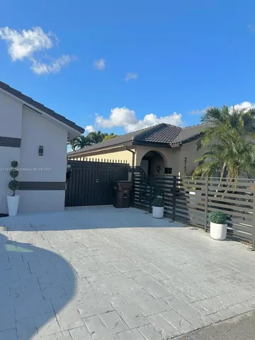 a black car parked in front of a house
