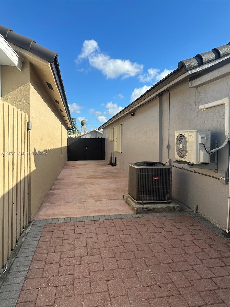 2753 West 68th Place Hialeah, FL 33016 - Photo 2 of 10 a black car parked in front of a house