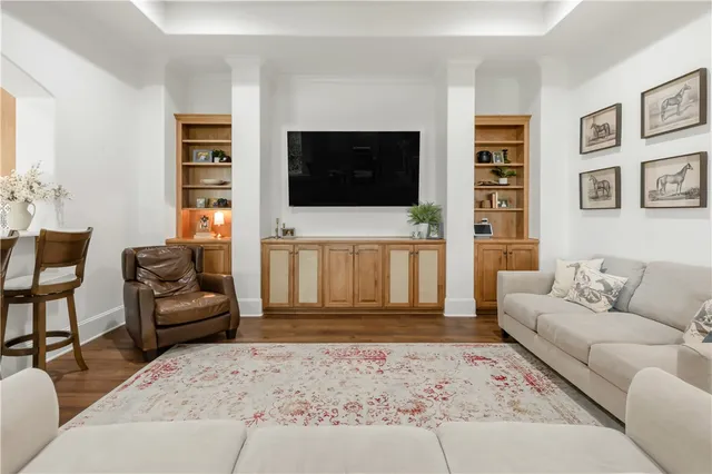 a living room with furniture and wooden floor