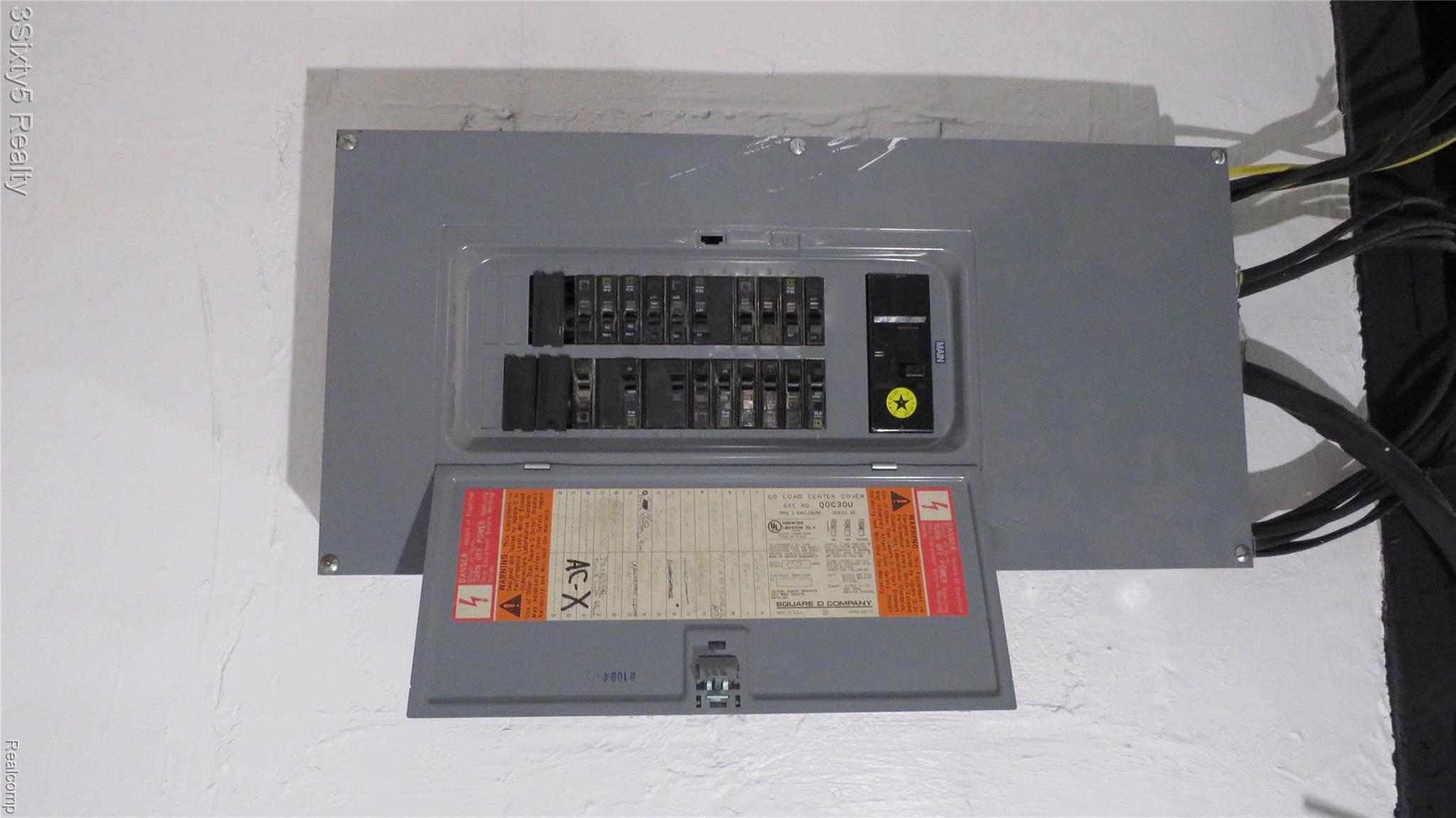 16558 Haggerty Road Belleville, MI 48111 - Photo 32 of 40 Electrical service panel with exposed circuit breakers and wiring conduit