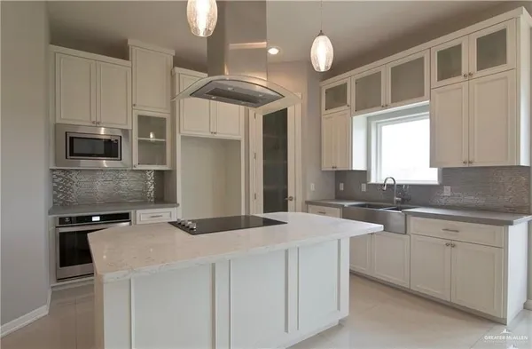 a kitchen that has a sink and a stove in it