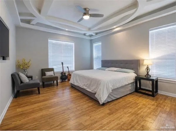 a bedroom with a bed wooden floor and lamp
