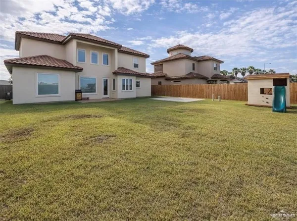 a front view of a house with a garden and deck