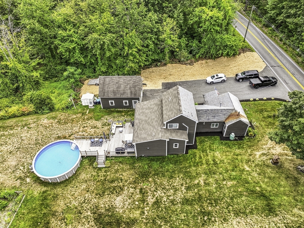 133 Rowley Hill Road Sterling, MA 01564 - Photo 12 of 41 an aerial view of a house with swimming pool and large trees