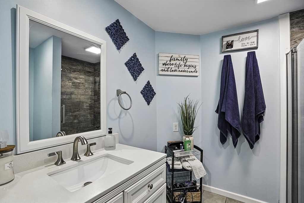 133 Rowley Hill Road Sterling, MA 01564 - Photo 33 of 41 a bathroom with a sink a mirror and a potted plant
